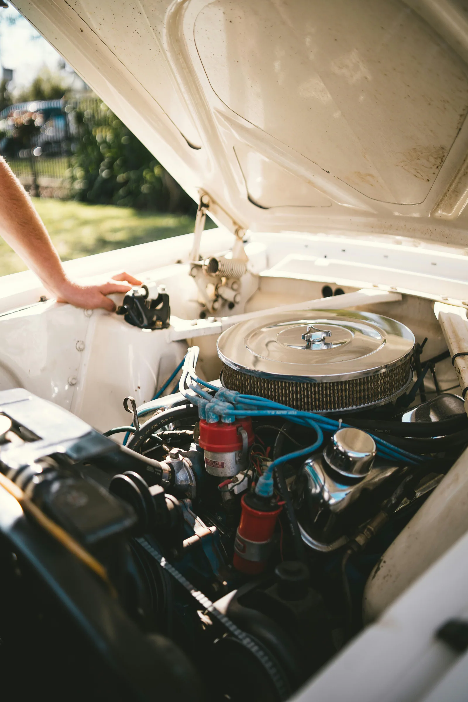 Person inspecting a car engine for troubleshooting