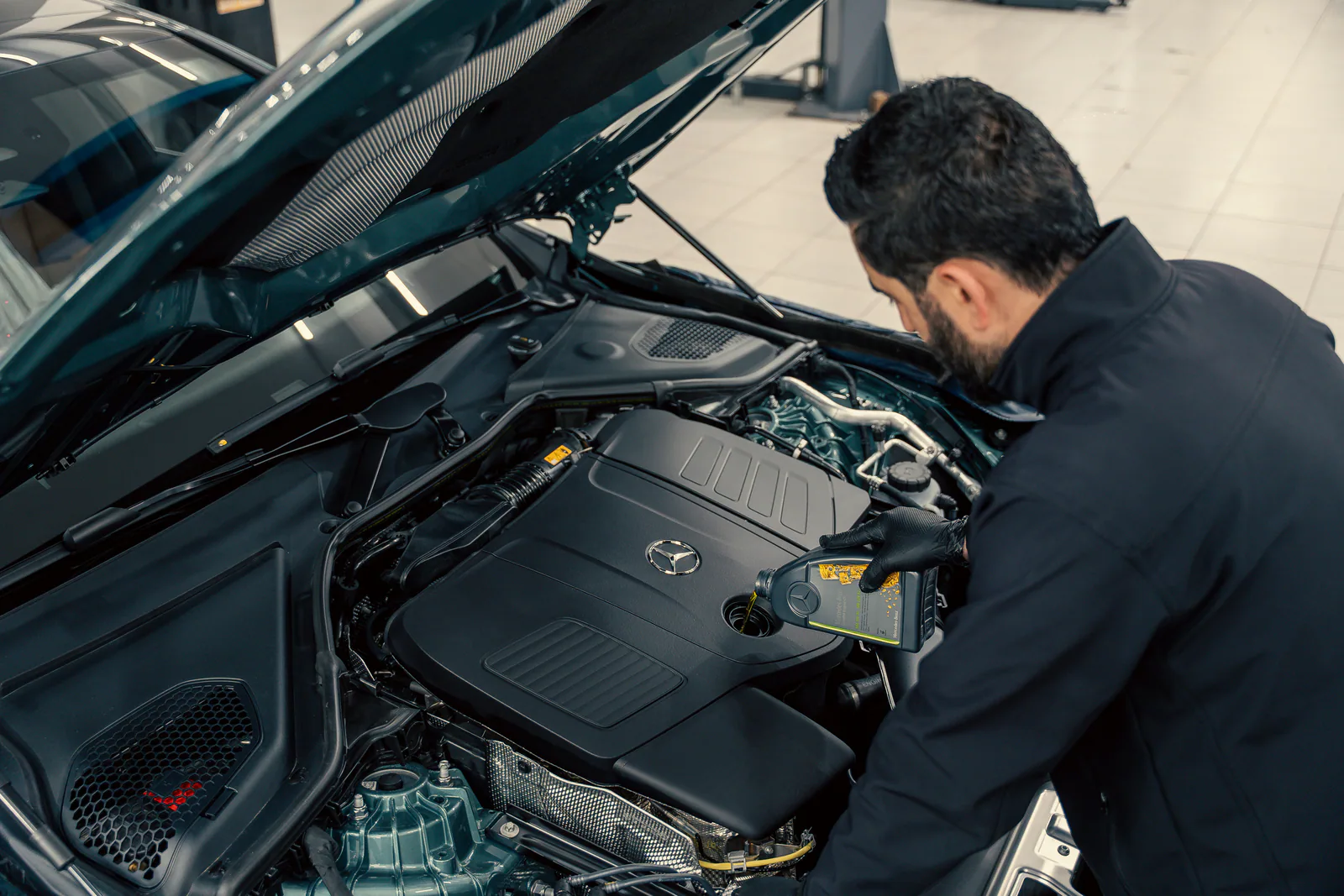 Mechanic working under the hood of a car