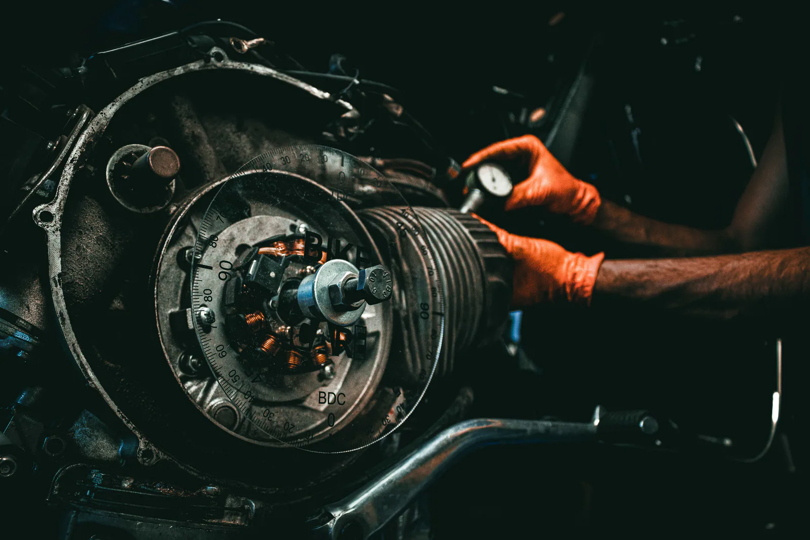 Certified auto mechanic inspecting an alternator