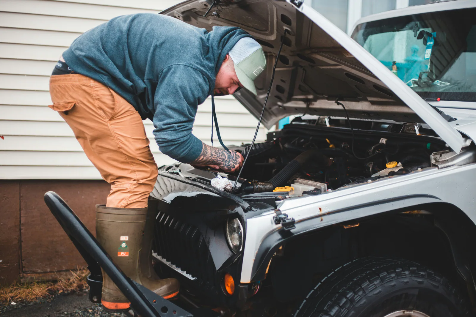 A mechanic using advanced diagnostic tools on a car's AC system