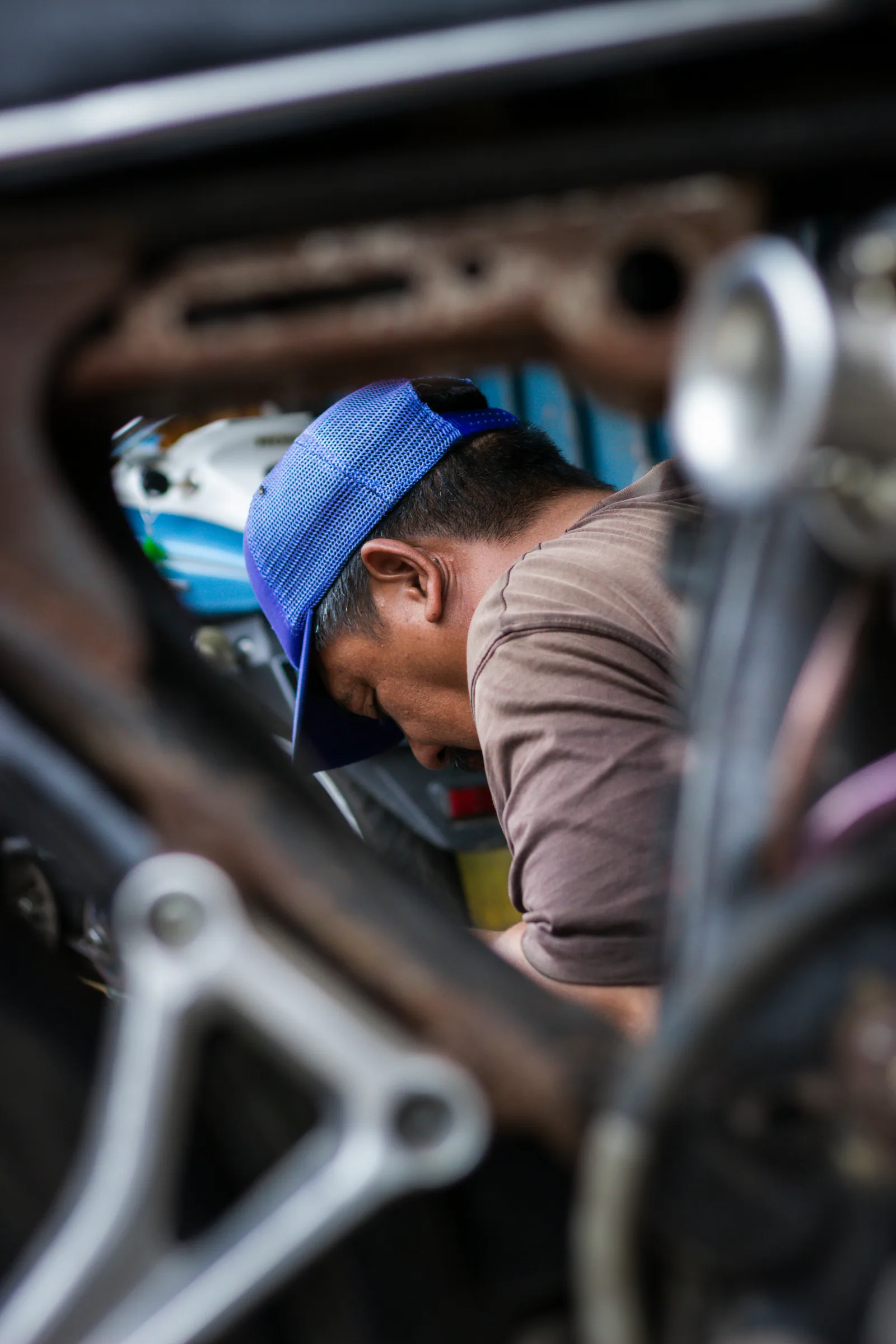Mechanic inspecting car alternator
